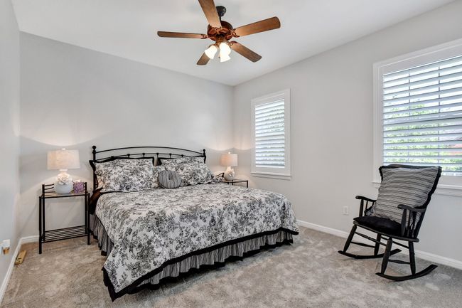 Bedroom featuring light carpet and a ceiling fan | Image 25