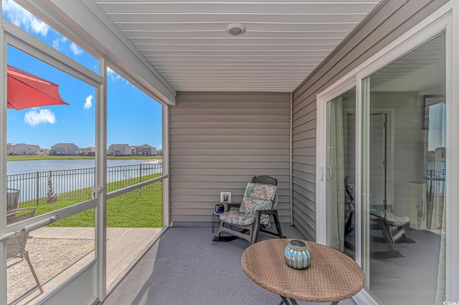 Sunroom featuring a water view | Image 20