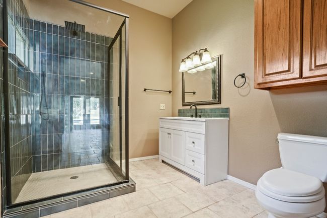 Full bath featuring a stall shower, vanity, and tile patterned flooring | Image 31