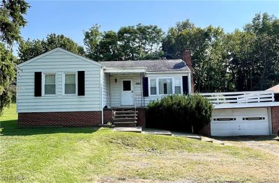 View of front of home featuring a garage and a front lawn | Image 1