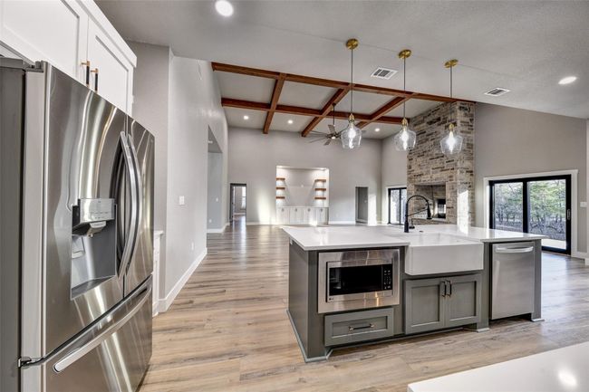 Kitchen with appliances with stainless steel finishes, gray cabinetry, coffered ceiling, pendant lighting, and beam ceiling | Image 19