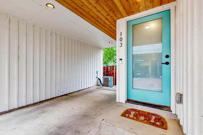 Doorway to property featuring board and batten siding, a patio, and central AC unit | Image 10