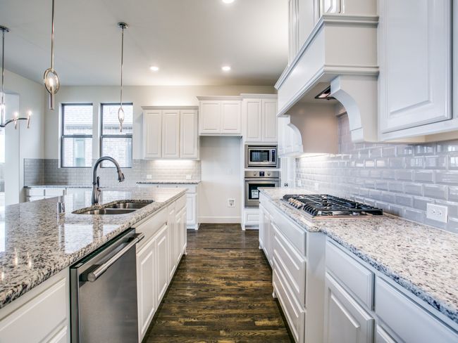 Kitchen featuring stainless steel appliances, white cabinetry, backsplash, dark wood-style flooring, and recessed lighting | Image 10