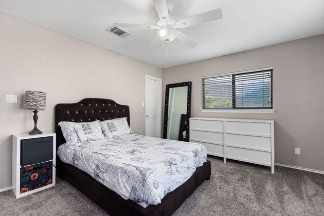 Carpeted bedroom featuring ceiling fan and baseboards | Image 31