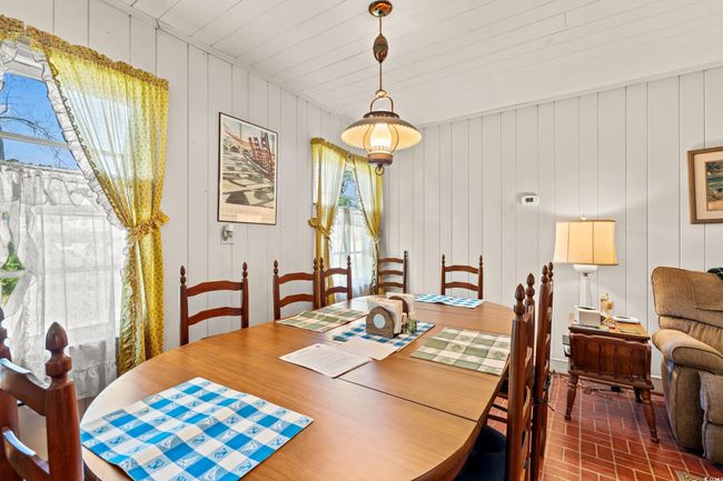 Dining space with brick flooring and plenty of natural light | Image 10