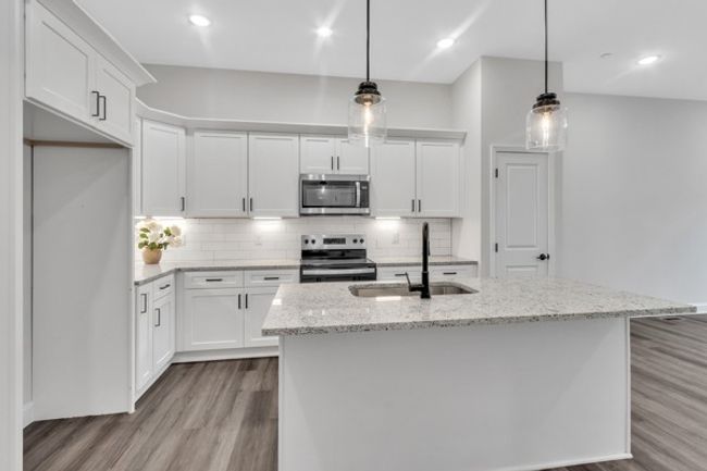 The 2nd floor features the kitchen, living space and a guest bedroom with a walk in closet and full bath on this floor. | Image 9