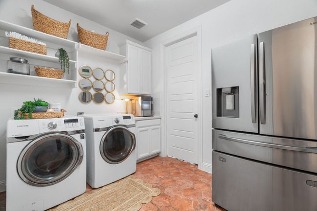Washroom featuring washer and clothes dryer and cabinet space | Image 22