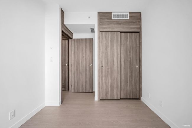 Unfurnished bedroom with light wood-style flooring and a closet | Image 17