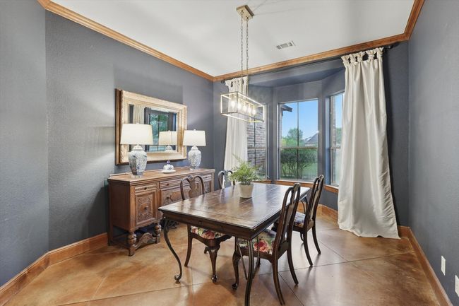 Dining space with baseboards and concrete flooring | Image 12