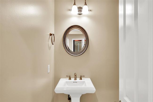 The Half Bath is very spacious with toilet to right out of camera range. It is located off of Entry Hallway as you enter the home. | Image 13