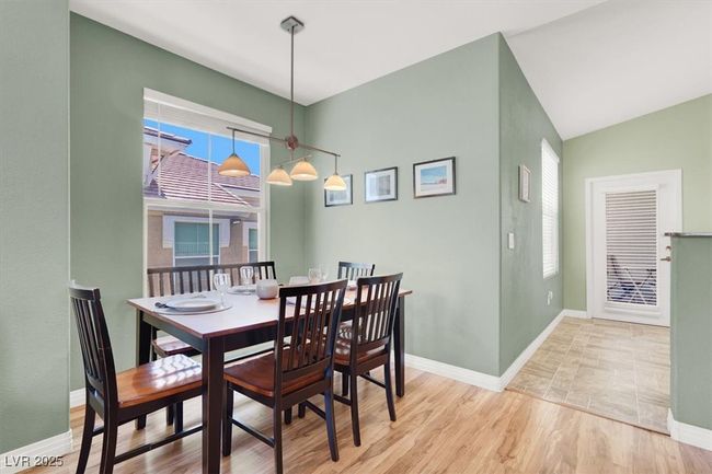 Dining room featuring lofted ceiling, wood like finished floors, and baseboards | Image 12