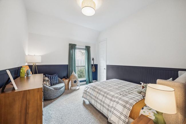 The fourth bedroom is spacious and features elegant carpeting, showcasing a classic design that offers comfort and timeless appeal. | Image 25