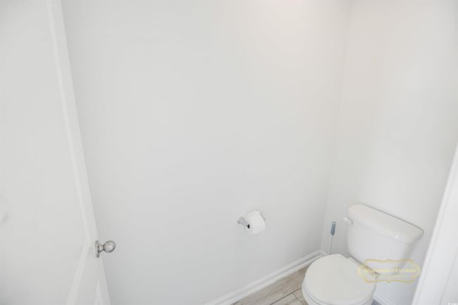 Bathroom with toilet and baseboards | Image 24