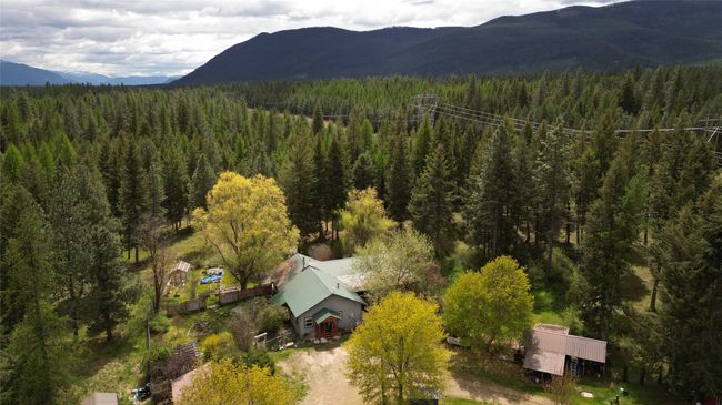 View of subject property with a heavily wooded area and a mountainous background | Image 78