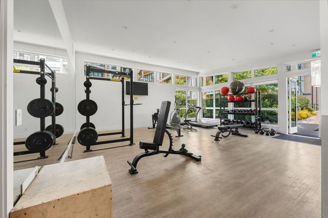 Exercise room featuring baseboards, wood finished floors, and a healthy amount of sunlight | Image 30