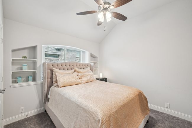Bedroom #3 featuring carpet, ceiling fan, built-ins, ceiling fan, and walk-in closet | Image 32