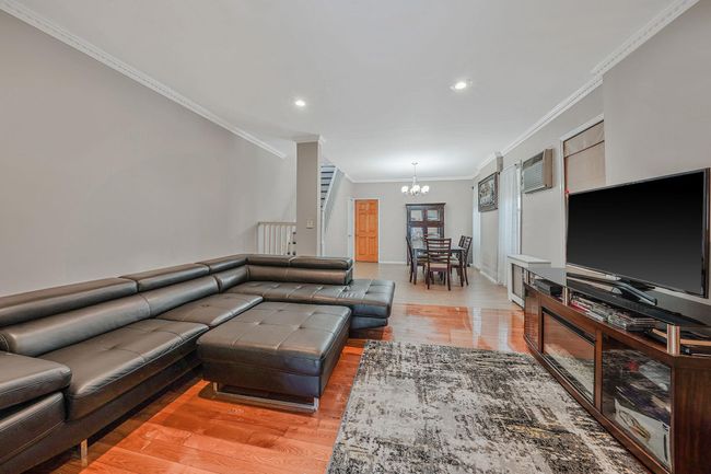 Living area featuring a chandelier, crown molding, light wood-style flooring, recessed lighting, and baseboards | Image 6