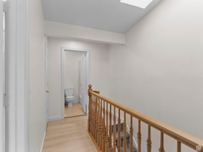 Corridor featuring an upstairs landing, a skylight, and light wood-style flooring | Image 10