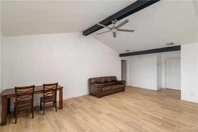 Sitting room featuring ceiling fan, lofted ceiling with beams, and light hardwood / wood-style flooring | Image 3