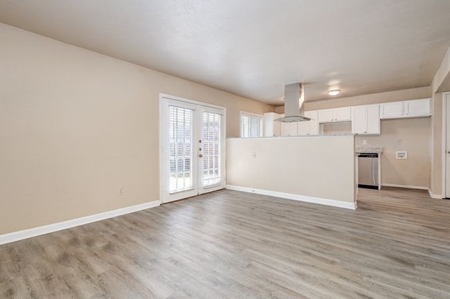 Unfurnished living room with light wood-style floors and baseboards | Image 9