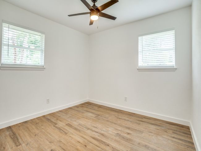 Spare room with baseboards, a ceiling fan, and light wood-style flooring | Image 12