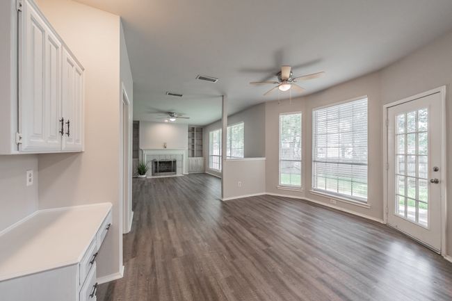 Breakfast area with ceiling fan and a desk for the organized home cook. | Image 16