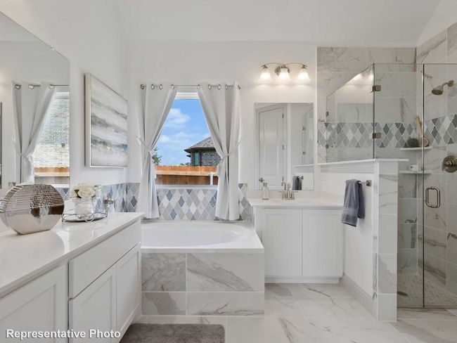 Bathroom featuring a shower stall, marble finish floor, a garden tub, and vanity | Image 9
