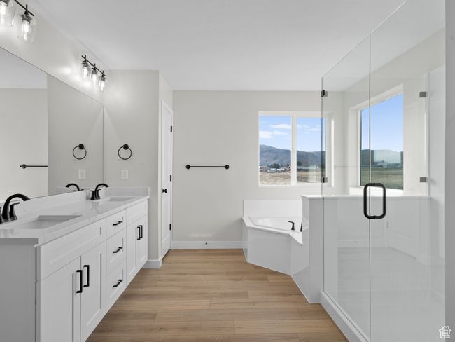 Bathroom with wood finished floors, a sink, a bath, and a mountain view | Image 22