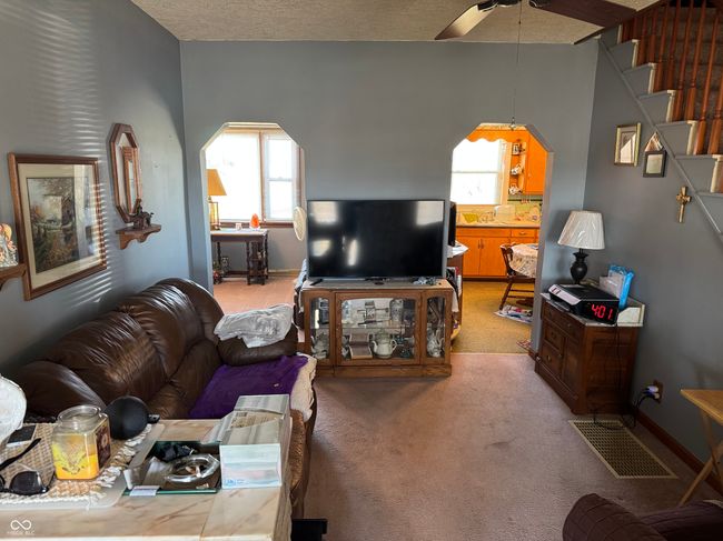 living area featuring light colored carpet, visible vents, ceiling fan, and baseboards | Image 27