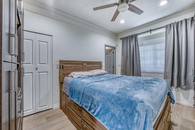 Bedroom featuring crown molding, light wood finished floors, recessed lighting, and a ceiling fan | Image 16