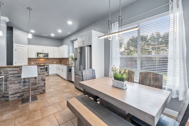 Really light and bright breakfast area overlooking the back yard and pool. | Image 6