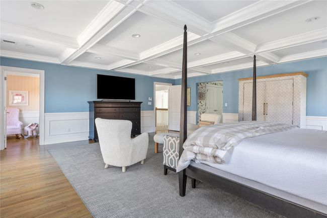 Bedroom with coffered ceiling, beam ceiling, visible vents, and light wood-style flooring | Image 29