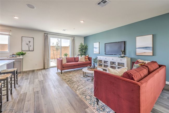 Living area with light wood-style flooring, baseboards, and recessed lighting. Photo is representational only; actual home finishes may vary | Image 10