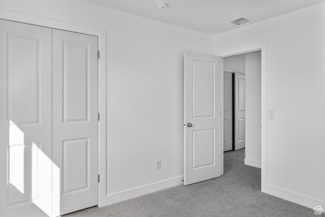 Unfurnished bedroom featuring baseboards and light carpet | Image 14