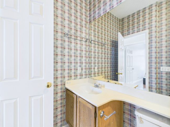 Half bathroom with wallpapered walls and vanity | Image 33