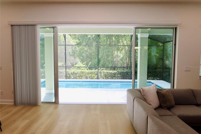 Sliding Glass Doors to Covered Patio and Screened in Pool | Image 10
