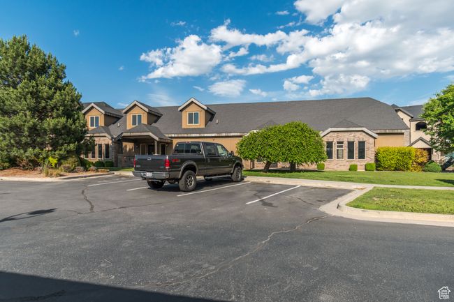 View of front of property with uncovered parking, a front yard, and stone siding | Image 13