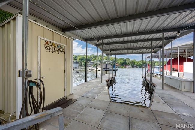 Dock area with boat lift and a water view | Image 34