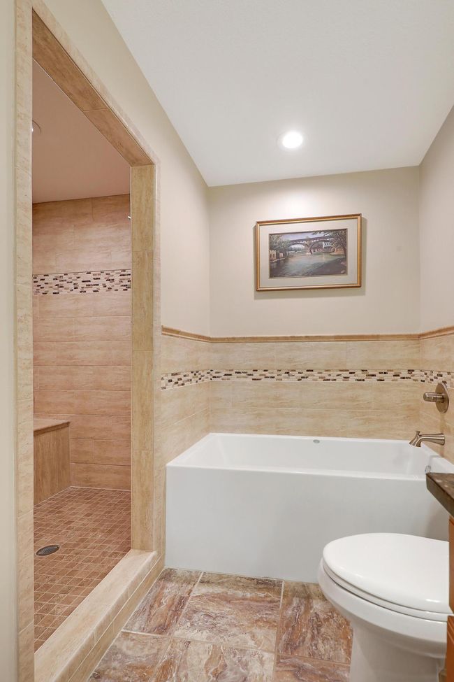 Deep soaking tub and large walk-in tiled shower. | Image 26