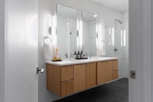 Full bath featuring a tile shower, tile walls, tile patterned flooring, and a sink | Image 21