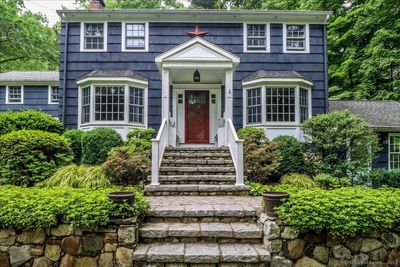 Stately colonial with beautiful details and wood siding. | Image 2