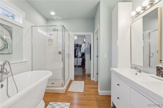 Bathroom featuring vanity, a shower stall, wood finished floors, and a freestanding bath | Image 21