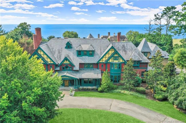 JACK FRANZEN // This modern day Queen Anne Victorian designed by renowned architect, Jack Franzen, is a custom masterpiece. Classic mix of elements include: Vermont slate roof, brick, clapboard, shingles, cross gables, turrets, half timber detailing, corbeled chimneys, turned wood columns and more. | Image 34