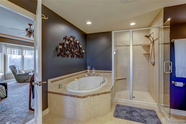 Master bath with jetted tub, Euro shower and custom tile work | Image 26