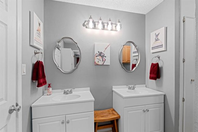 Secondary bathroom with dual vanities. | Image 13
