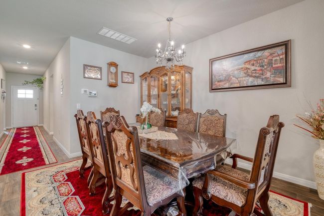 Dining room with a chandelier, and baseboards | Image 9