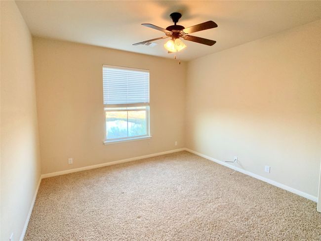 Carpeted spare room with ceiling fan and baseboards | Image 8
