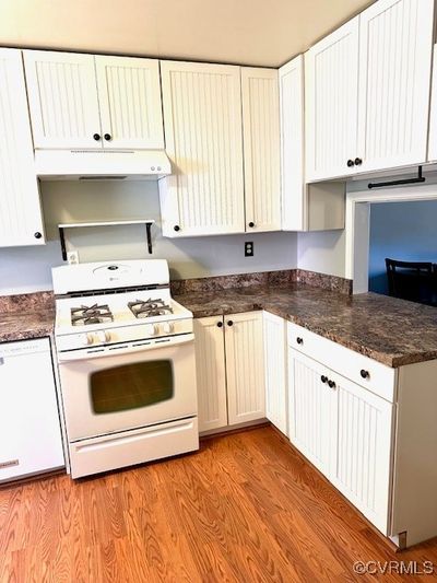 Featuring white cabinetry, newer counters, gas stove | Image 2