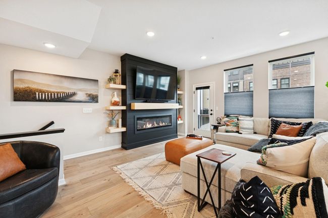 Striking black slat wall with a built-in electric fireplace and mounted TV—perfect for cozy nights on the couch in style and comfort. | Image 11