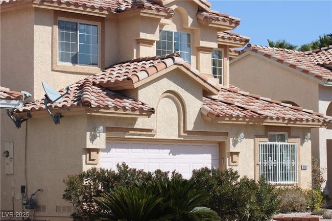 View of front of property featuring a tiled roof and stucco siding | Image 8